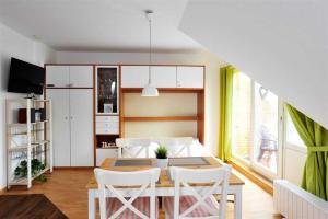 a dining room with a table and white chairs at Wohnung 5 ID 103 in Böhl +9 photos