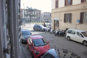 a group of cars parked on a city street at Soggiorno Madrid in Florence
