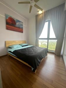 a bedroom with a bed and a large window at The Clio 2 IOI Resort City, Beside IOI City Mall, beside conezion, opposite hospital serdang , UPM and uniteen in Putrajaya +15 photos