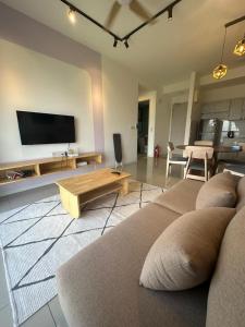 a living room with a couch and a table at The Clio 2 IOI Resort City, Beside IOI City Mall, beside conezion, opposite hospital serdang , UPM and uniteen in Putrajaya