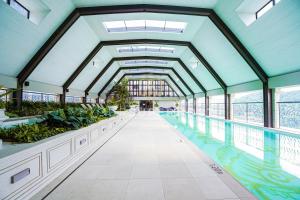 an indoor pool with plants in a building at Paxtonz by YourSuperhost in Kuala Lumpur +37 photos