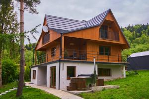 a house with a gambrel roof on top of it at Tylko tu Bieszczady, Balia, Sauna in Baligród