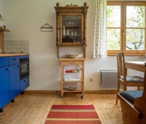 a kitchen with a table and a cabinet in it at Hütterhof in Grundlsee +10 photos