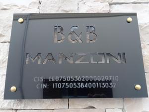 a sign for a manzos sign on a building at B&B Manzoni in Neviano