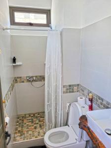 a small bathroom with a toilet and a sink at Freesia Studio by Mau-Rent Houses in Trou aux Biches