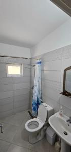a bathroom with a toilet and a sink at Loft Apartments in Sarandë +22 photos