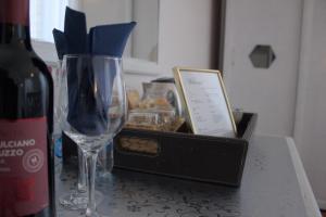 a table with a wine glass and a box of cookies at Soggiorno Madrid in Florence
