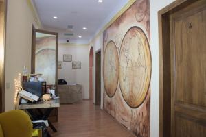 a hallway with a wall with clocks on it at Soggiorno Madrid in Florence