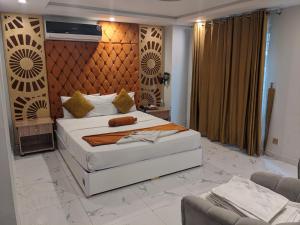 a bedroom with a large bed in a room at Nuva Hotel in Islamabad