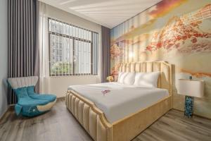 a bedroom with a bed and a chair and a window at Khánh Villa Phan Tôn Venue stay in Da Nang +46 photos