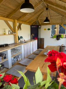 a room with a wooden table and a kitchen at Alexa Resort in Borovany
