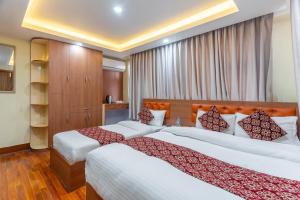 a hotel room with two beds in a room at OYO 831 Hotel Mission Inn Pvt Ltd in Kathmandu +51 photos
