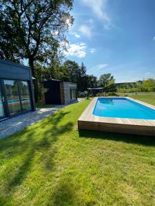 a swimming pool in the yard of a house at Alexa Resort in Borovany