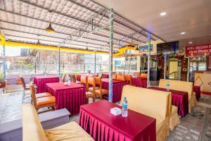 a restaurant with red tables and chairs in a room at OYO 831 Hotel Mission Inn Pvt Ltd in Kathmandu