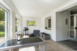 a living room with a table and a chair at Ferienwohnung Auszeit Sauerland in Meinerzhagen +19 photos