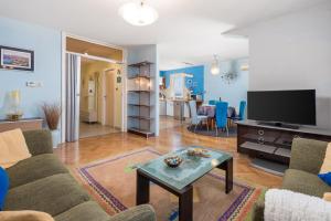 a living room with a couch and a tv at Apartman Kvarner in Rijeka