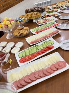 a table topped with lots of different types of food at Caravan Hotel in Karakol