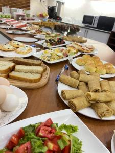 a long table with plates of food on it at Caravan Hotel in Karakol +24 photos
