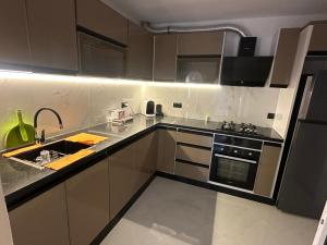 a kitchen with a sink and a stove at Mazagan Home in El Jadida +8 photos