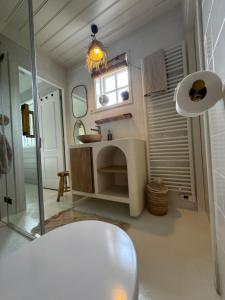 a bathroom with a sink and a mirror at Casa Pueblo Viejo in Ouddorp