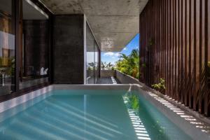 a swimming pool in the middle of a house at Thè HEM Hotel and Apartment in Danang