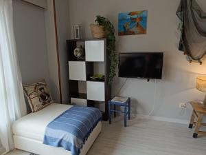 a bedroom with a bed and a tv and a chair at Marusia in Viveiro