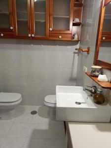 a bathroom with a white sink and a toilet at Marusia in Viveiro +23 photos