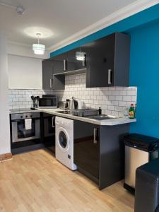 a kitchen with a sink and a washing machine at Apt 5a Central by river 1 Bed Apartment in Norwich