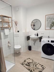 a bathroom with a sink and a washing machine at Hygge Homes - Design Apartment Nähe Schloss in Celle +6 photos