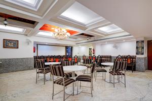 a dining room with tables and chairs and a ceiling at Super Townhouse Civil Aviation HAL Road in Bengaluru