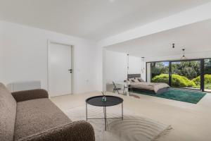 a living room with a couch and a table at Villa Carla house with hot tub and beautiful garden in Ičići