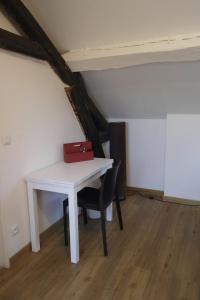 a white table with a red briefcase on it in an attic at Bel F2 Nogent Gare sur place in Nogent-lʼArtaud