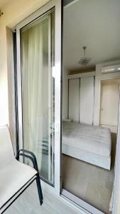a room with a bed and a sliding glass door at Apartment Del Mare in Boreti