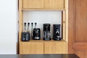 een plank met een heleboel apparaten in een keuken bij Gîte de l'Oriel - Gîte avec Grand Jardin in Sainte-Marie-aux-Mines +13 foto's