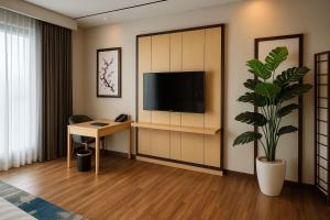 A television and/or entertainment centre at The Bellezza Hotel Suites