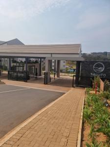 a gas station with a sign in front of it at paradise in Ballito in Ballito