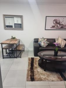 a living room with a couch and a table at paradise in Ballito in Ballito