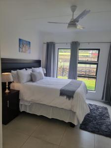 a bedroom with a large bed and a window at paradise in Ballito in Ballito +15 photos
