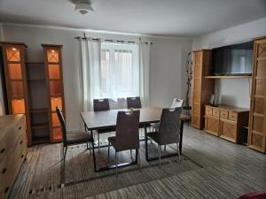 a dining room with a table and chairs at Dům u parku in Znojmo