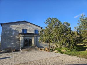 a house with a stone driveway in front of it at Aegviidu Mäe Maja in Aegviidu