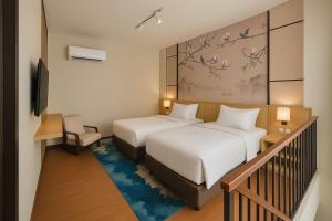 A bed or beds in a room at The Bellezza Hotel Suites