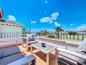 a patio with a table and chairs on a balcony at Mar Menor Golf Villa - 6310 in Torre-Pacheco