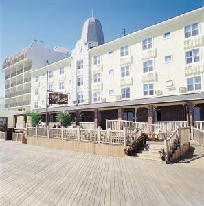 a large white building with stairs in front of it at Plim Plaza Hotel in Ocean City