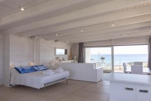 a bedroom with a bed and a view of the ocean at Casa Dansodà sul mare in Torre Lapillo