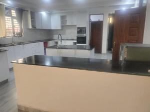a kitchen with a black counter top in a room at Blessed Home, Nakuru in Nakuru