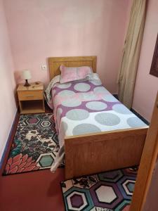 a small bedroom with a bed and a rug at Chalet Panorama in Ouaouizarht +34 photos