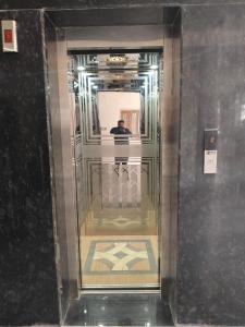 a man standing in a elevator in a building at Hotel Dev Inn Ayodhya in Ayodhya