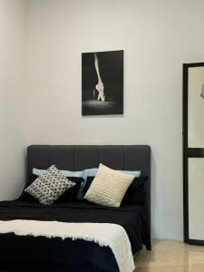 a bed with pillows on it in a room at Kemaman AY Home in Cukai