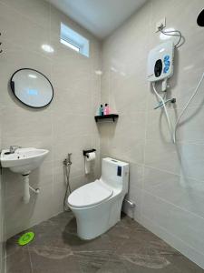 a bathroom with a toilet and a sink at Kemaman AY Home in Cukai +15 photos