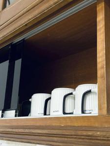 a row of white chairs sitting on a window sill at Kemaman AY Home in Cukai